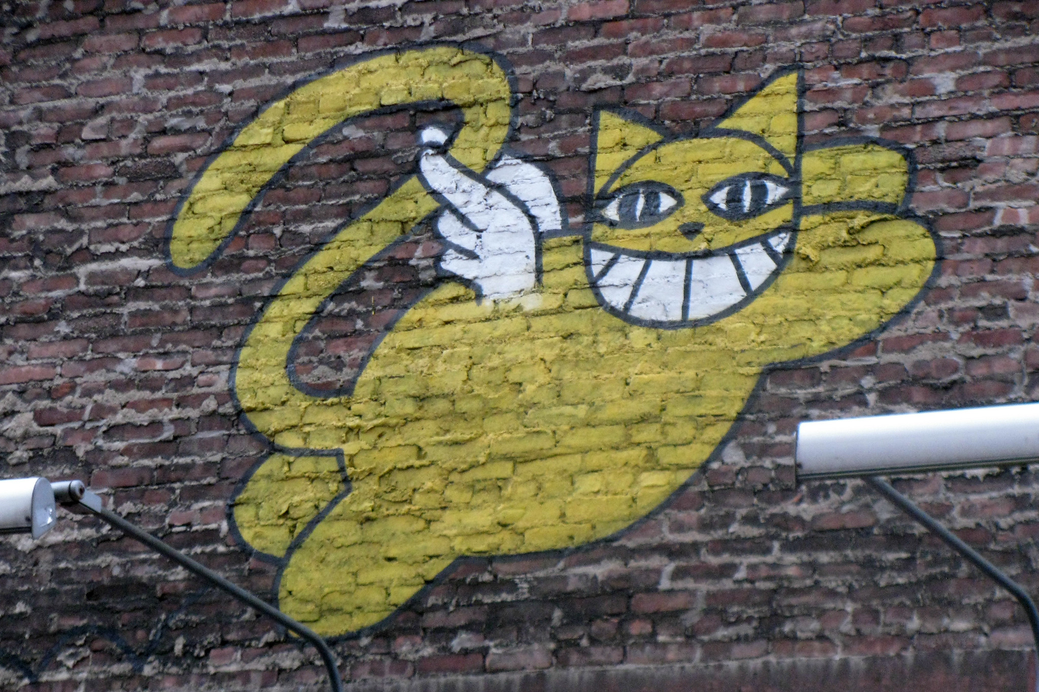 Yellow Angel Cat On a Brick Wall – New York Street Art